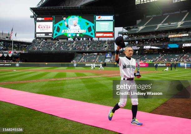 Former Seattle Mariners player Ichiro Suzuki tips his cap to the crowd as he walks off the field after receiving the Seattle Mariners Franchise...