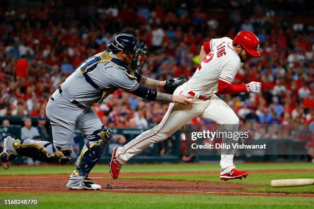 Yasmani Grandal of the Milwaukee Brewers tags out Paul DeJong of the St. Louis Cardinals in the sixth inning at Busch Stadium on September 14, 2019...