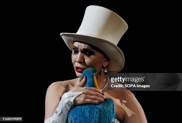 An artist hugs a parrot during the presentation of the new fantasy steampunk circus show 'Pendulum of Time' at the Ukrainian National Circus in Kiev,...