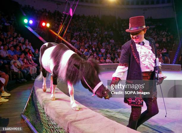 An artist performs with a horse during the presentation of the new fantasy steampunk circus show 'Pendulum of Time' at the Ukrainian National Circus...