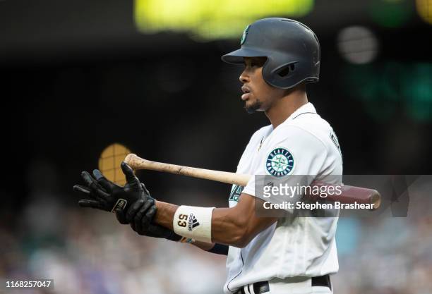 Keon Broxton of the Seattle Mariners adjusts his batting glozes before an at-bat during a game against the Tampa Bay Rays at T-Mobile Park on August...
