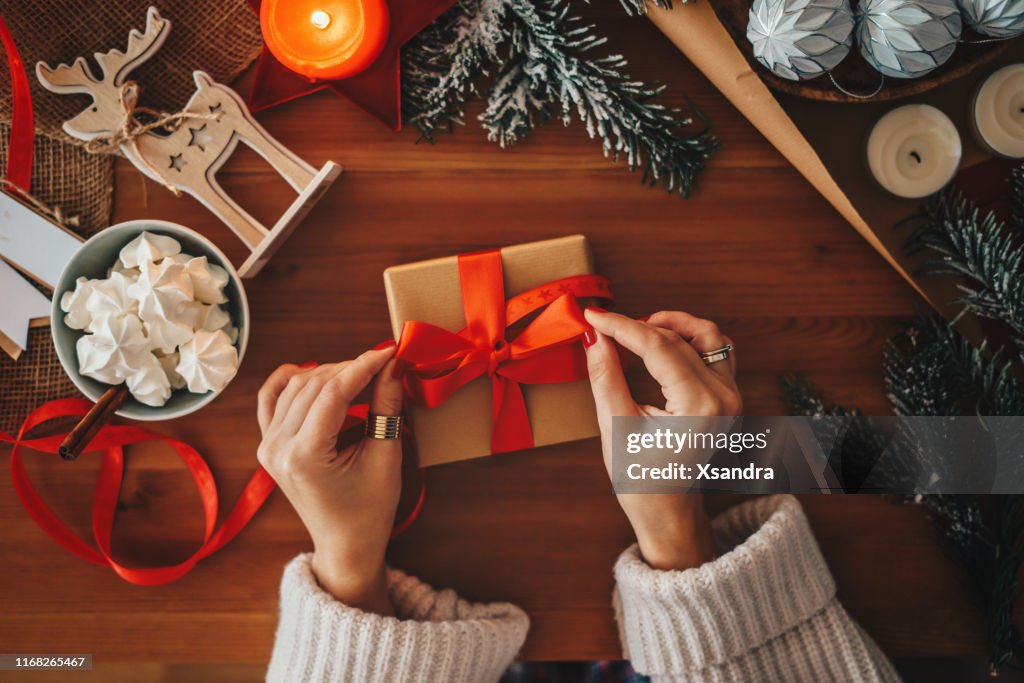 Mujer envolviendo regalos de Navidad, tiro de arriba