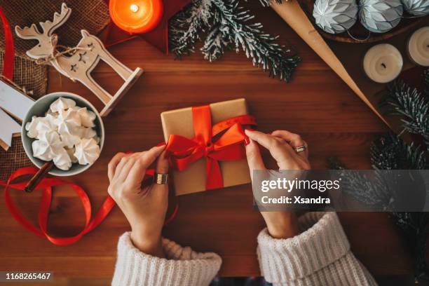 woman wrapping christmas gifts, overhead shot - christmas flatlay stock pictures, royalty-free photos & images