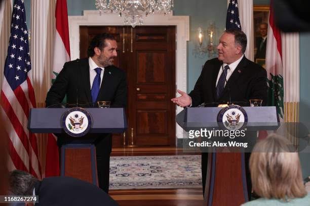Secretary of State Mike Pompeo makes remarks to members of the media as Lebanese Prime Minister Saad Hariri listens at the State Department August...