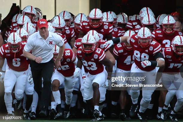 Head coach Scott Frost of the Nebraska Cornhuskers leads the team on the field against the Northern Illinois Huskies at Memorial Stadium on September...