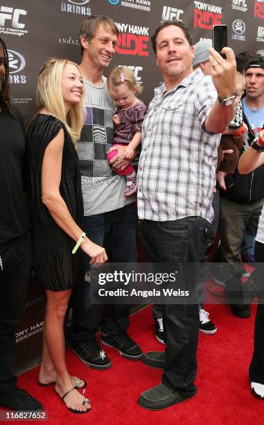 Lhotse Merriam, Tony Hawk, their daughter Kadence Clover Hawk and Jon Favreau arrive to the 'Tony Hawk: Ride Presents Stand Up For Skateparks'...