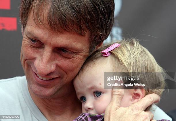 Tony Hawk and his daughter Kadence Clover Hawk attend the 'Tony Hawk: Ride Presents Stand Up For Skateparks' benefit press conference held at the...