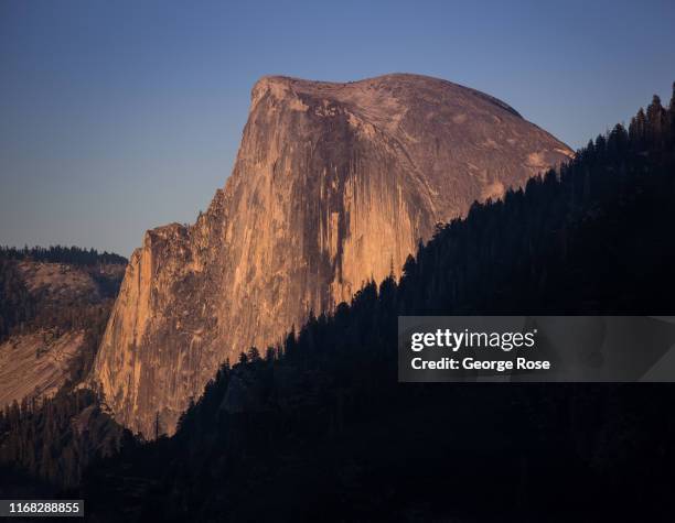 Half Dome is viewed from Tunnel View at sunset on August 13 in Yosemite Valley, California. With the arrival of summer, the estimated 600,000 monthly...