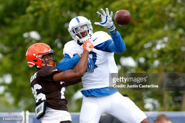 Devin Funchess of the Indianapolis Colts catches the ball while being defended by Greedy Williams of the Cleveland Browns during the joint practice...
