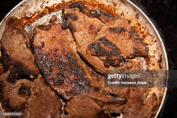 burned liver in a frying pan. - beef liver stock pictures, royalty-free photos & images