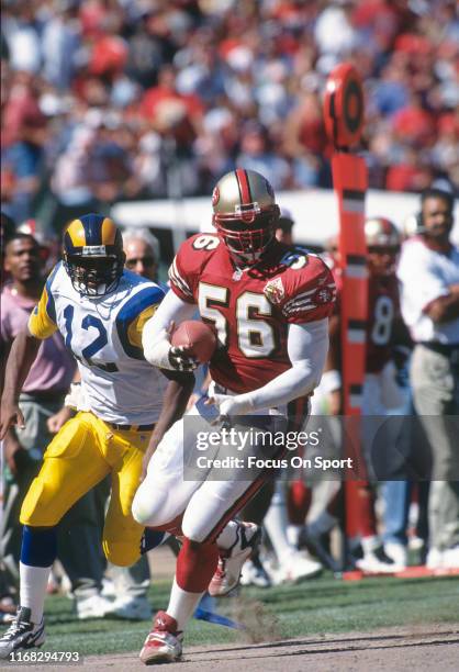 Chris Doleman of the San Francisco 49ers runs with the ball against the St. Louis Rams during an NFL football game October 12, 1997 at Candlestick...