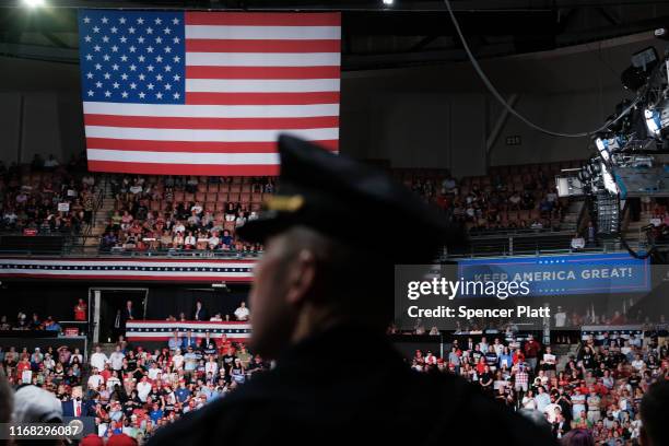 Police officer stands guard as President Donald Trump speaks to supporters at an evening rally on August 15, 2019 in Manchester, New Hampshire. The...