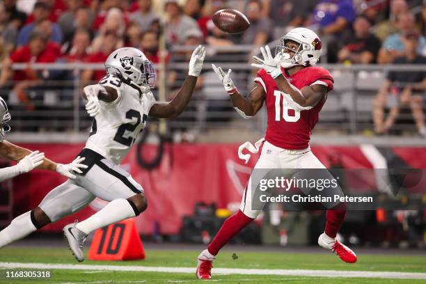 Wide receiver Trent Sherfield of the Arizona Cardinals catches a 40 yard touchdown reception ahead of cornerback Nick Nelson of the Oakland Raiders...