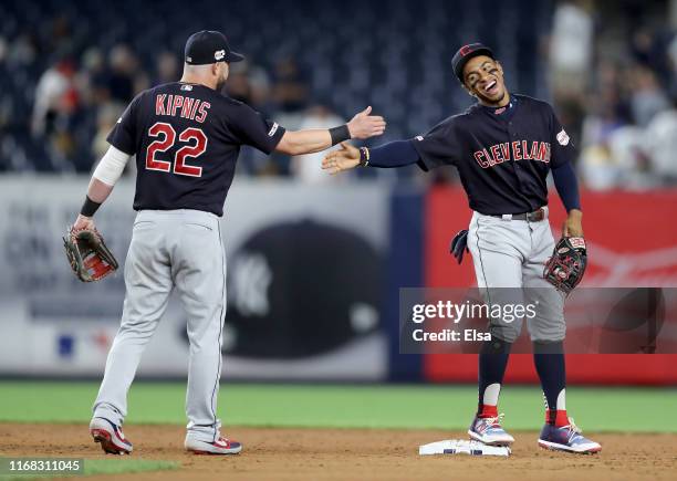 Francisco Lindor of the Cleveland Indians celebrates the 19-5 win over the New York Yankees with teammate Jason Kipnis at Yankee Stadium on August...