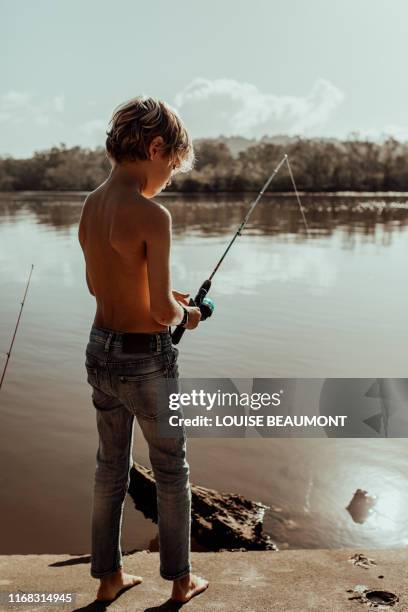 young boy patiently fishing - brunswick heads nsw stock pictures, royalty-free photos & images