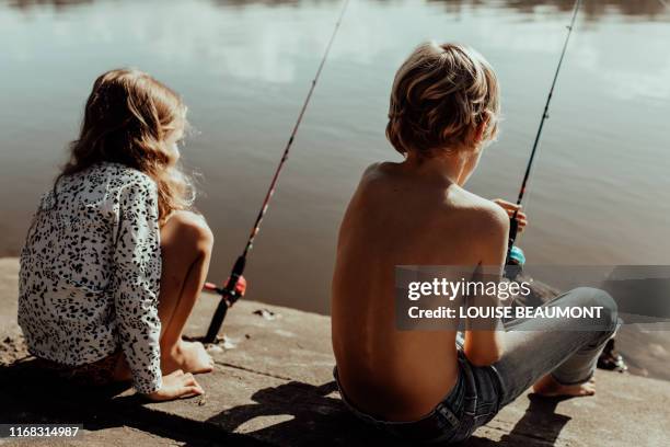 siblings fishing alongside one another - brunswick heads nsw stock pictures, royalty-free photos & images