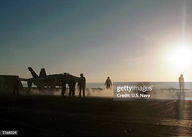 Navy personnel prepare to launch an F/A-18 "Hornet" October 23, 2001 from the flight deck of the USS Carl Vinson. The USS Carl Vinson is conducting...