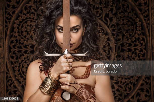 beautiful brunette ethnic warrior woman wearing henna tattoo - indian warrior tattoo stock pictures, royalty-free photos & images