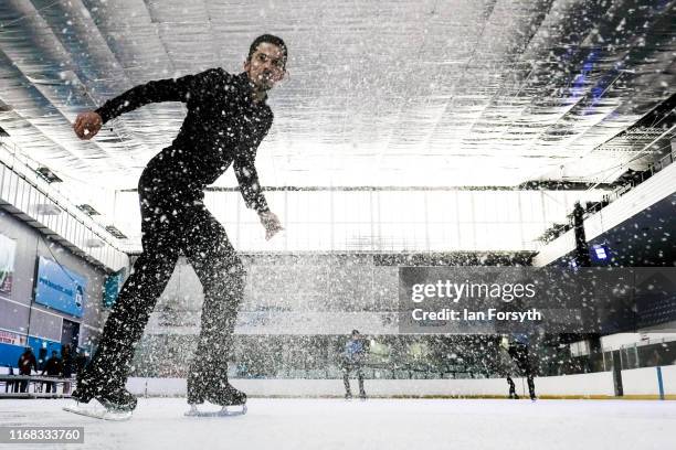 Figure skater John Kerr, seven times UK National Champion and Bronze medallist at the European Championships sprays ice as he comes to a stop during...