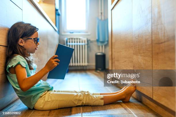 you can't keep a good book down - girl looking down stock pictures, royalty-free photos & images