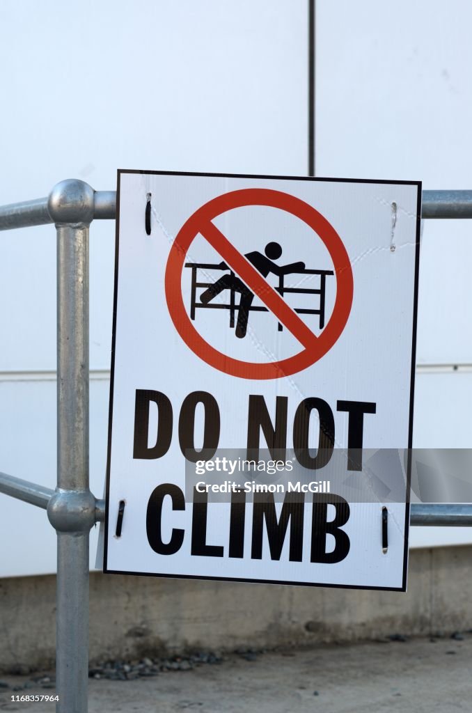 Warning Railing Signage Do Not Climb Warning Sign On Metal Railings High-Res Stock Photo ...