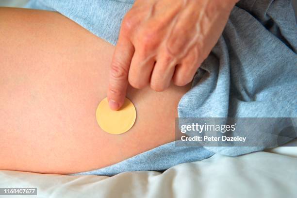 hrt patch for mature woman at menopause - oestrogen stock pictures, royalty-free photos & images