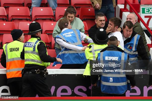 Fans fighting in the stands during the Sky Bet Championship match between Barnsley and Leeds United at Oakwell Stadium on September 15, 2019 in...