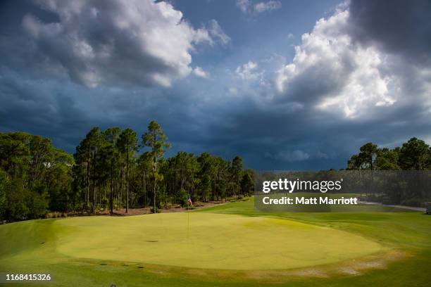 Dark skies hang over the 18th green at the Concession Golf Club in Bradenton, Florida during a weather delay. Emma Talley of the University of...