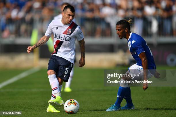 Florian Aye of Brescia Calcio competes with Gary Medel of Bologna FC during the Serie A match between Brescia Calcio and Bologna FC at Stadio Mario...