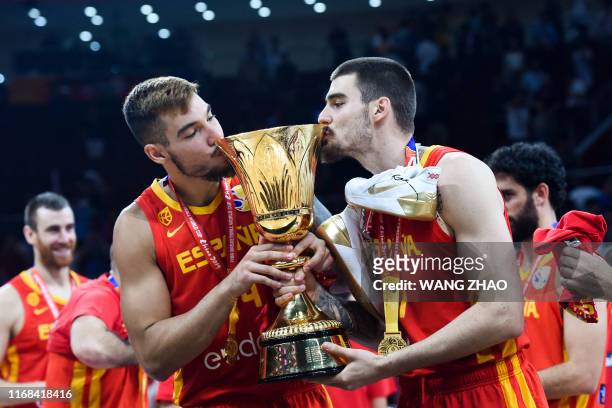 Spain's Willy Hernangomez and Juan Hernangomez kiss their winning trophy at the end of the Basketball World Cup final game between Argentina and...