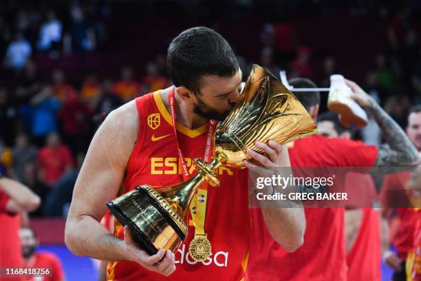 Spain's Marc Gasol celebrates with their winning trophy at the end of the Basketball World Cup final game between Argentina and Spain in Beijing on...