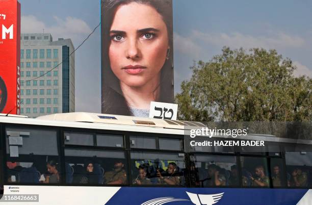 Bus drives below an electoral billboard with the portrait of Ayelet Shaked, chairwoman of Israel's United Right party, in the southern city of...