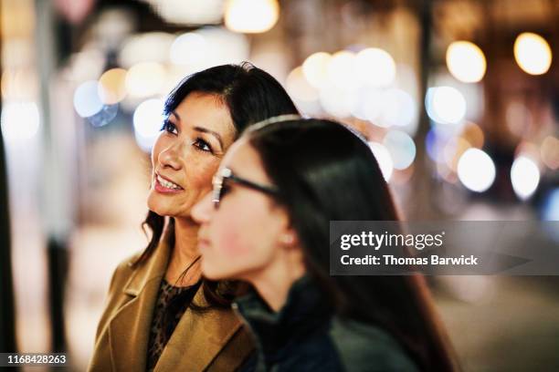 smiling mature woman window shopping with teenage daughter during holidays - shopping friends family stock pictures, royalty-free photos & images