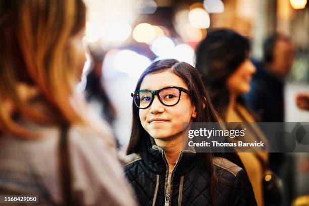 portrait of smiling young woman holiday shopping with friend on winter evening - korean teen - fotografias e filmes do acervo