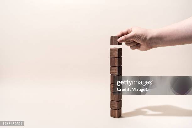 hand building brown wood blocks - mirage clutch stock pictures, royalty-free photos & images