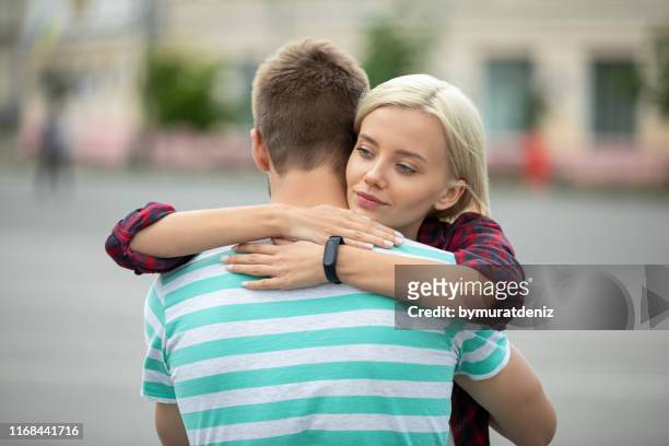sad woman hugging her boyfriend - hypocrisy stock pictures, royalty-free photos & images