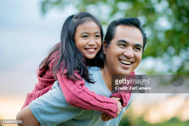happy father and daughter in the summertime - filipino family stock pictures, royalty-free photos & images