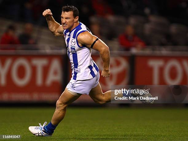 Brent Harvey of the Kangaroos celebrates a goal within the first minute of the game during the round 13 AFL match between the Essendon Bombers and...