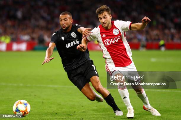 Joel Veltman of Ajax gets past the tackle from Omar El Kaddouri of PAOK during the UEFA Champions League 3rd Qualifying match between Ajax and PAOK...
