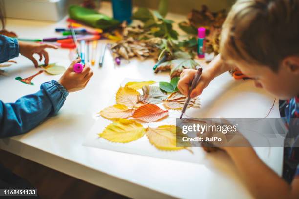 children doing autumn handcrafts - child stock pictures, royalty-free photos & images