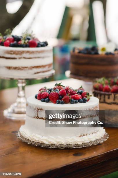 strawberry wedding cake at a smaller wedding celebration in a backyard in summer july - ショートケーキ ストックフォトと画像