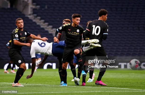 Japhet Tanganga of Tottenham Hotspur is challenged by Nabili Zoubdi Touaizi and Joel Latibeaudiere of Manchester City during the Premier League 2...