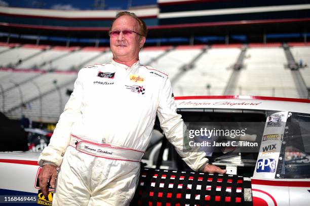 Morgan Shepherd, driver of the Visone RV Chevrolet, stands on the grid during qualifying for the NASCAR Xfinity Series Food City 300 at Bristol Motor...