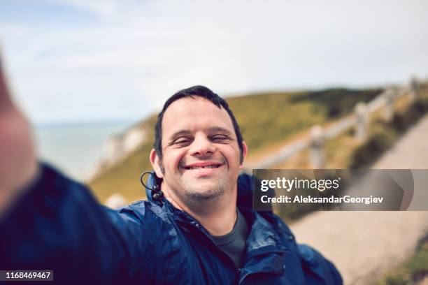 disabled man taking a selfie - windbreak stock pictures, royalty-free photos & images