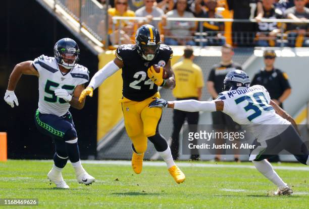 Benny Snell of the Pittsburgh Steelers rushes against Bradley McDougald and Mychal Kendricks of the Seattle Seahawks on September 15, 2019 at Heinz...