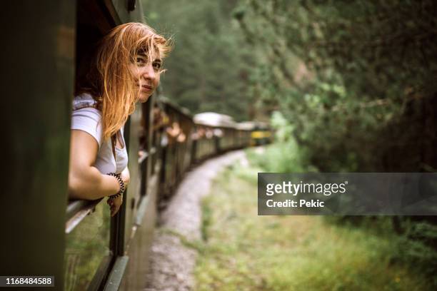 wind in her hair on train adventure - air serbia stock pictures, royalty-free photos & images