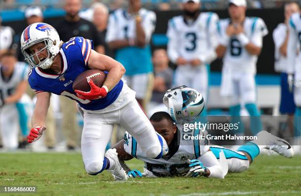 Jermaine Carter of the Carolina Panthers loses his helmet as he tackles Cole Beasley of the Buffalo Bills during the first quarter of their preseason...