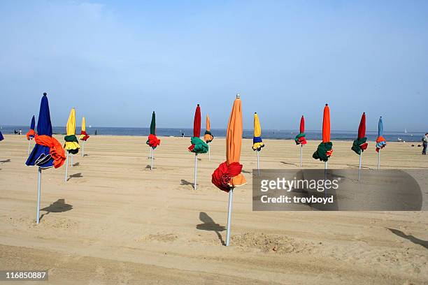 parasols on a beach - deauville beach stock pictures, royalty-free photos & images