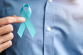 Prostate Cancer Awareness, Man holding light Blue Ribbon for supporting people living and illness. Men Healthcare and World cancer day concept