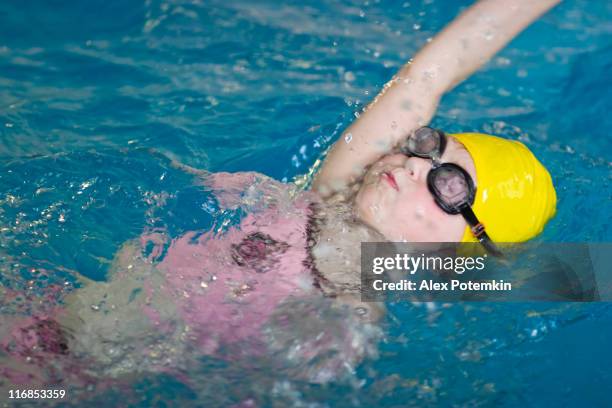swimming girl in the blue pool - backstroke stock pictures, royalty-free photos & images
